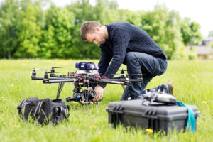 Drone operator setting up equipment covered by UAV insurance